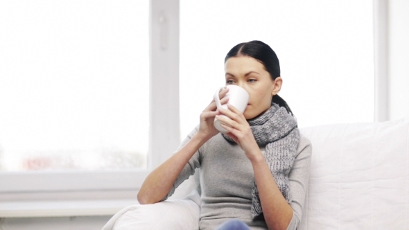 Ill Woman With Flu Drinking Hot Tea At Home