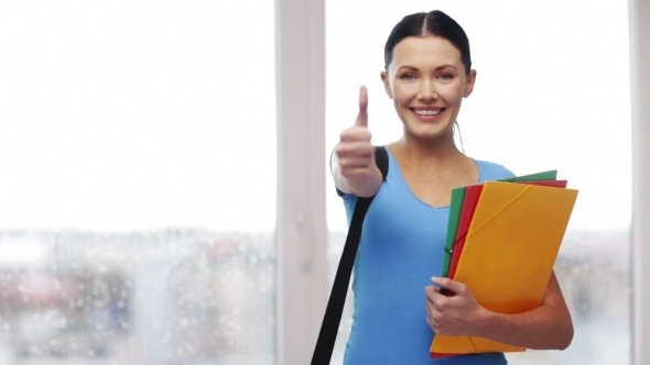 Student With Bag And Folders Showing Thumbs Up