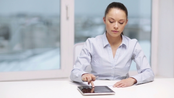 Business Woman With Tablet Pc And Papers In Office