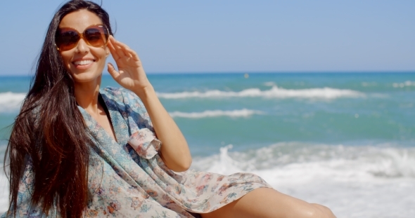 Pretty Young Woman Relaxing At The Beach Sand