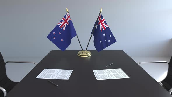 Flags of New Zealand and Australia and Papers on the Table