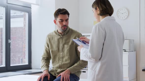 Doctor and Sad Man with Health Problem at Hospital