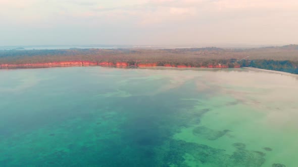 Aerial: uncontaminated coastline beach sunset Kei Islands Maluku Indonesia