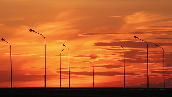 Cars Silhouettes On Road Against Sunset