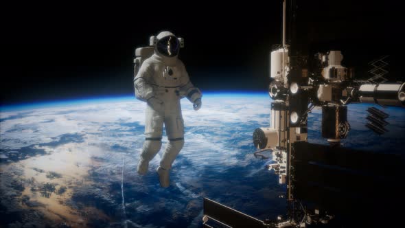 International Space Station and Astronaut in Outer Space Over the Planet Earth alt