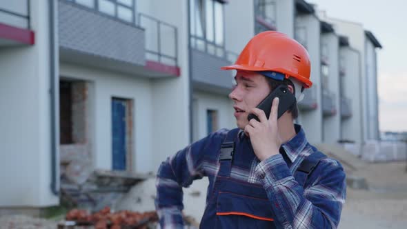 Worker Talks on His Phone About Work