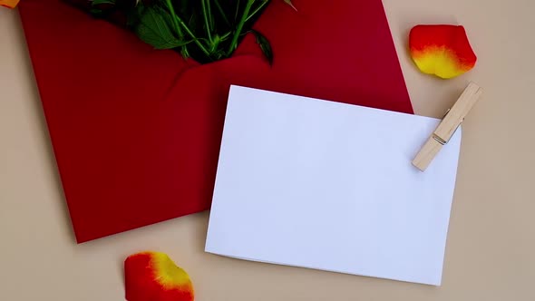 Bouquet of Red Roses Decorated in Paper Envelope on Beige Background