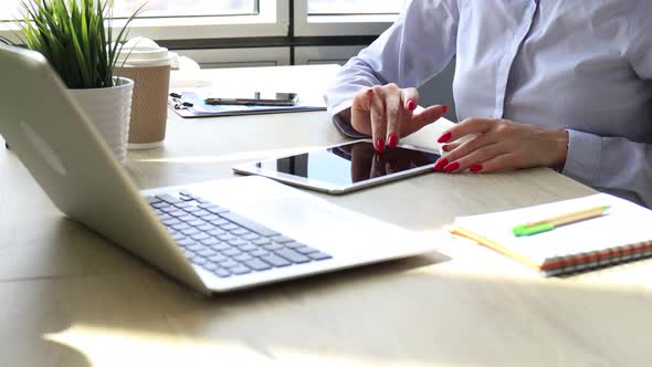 Young attractive smiling caucasian woman using tablet sitting at modern office.