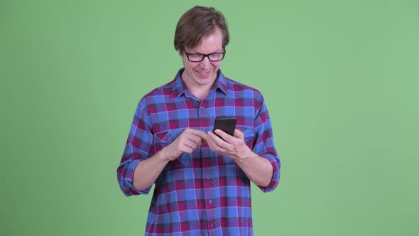 Happy Young Handsome Hipster Man Using Phone