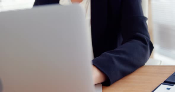 Businesswoman working over laptop at her desk