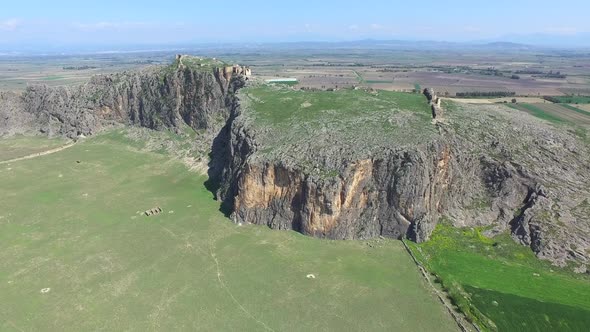 Castle On The Mountain Summit With High Cliff Rocky Wall