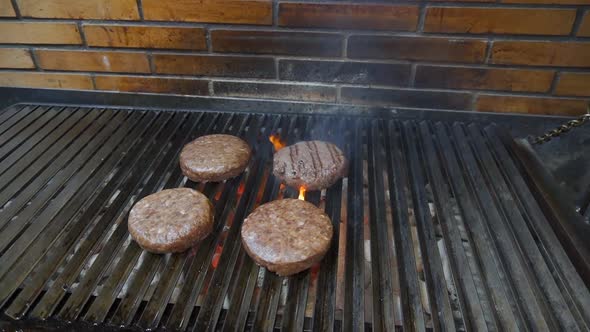 Burgers on the grill, flames coming out