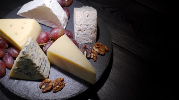 Assorted Cheeses with Nuts and Fruits on the Table, Rotating Video