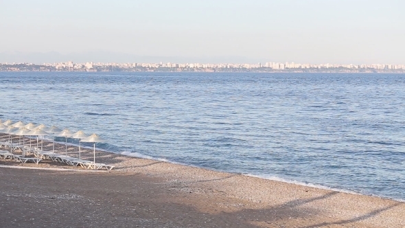 Many Straw Beach Umbrellas At The Seashore In