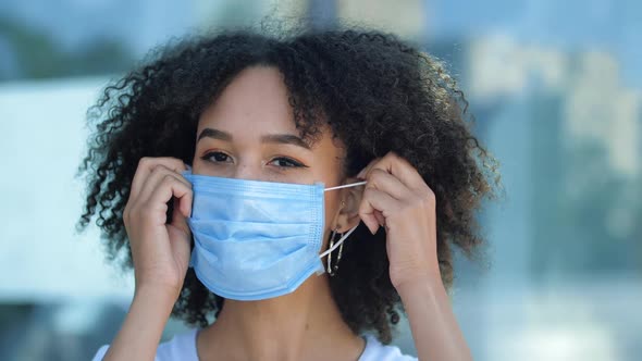 Beautiful Smiling Young African American Woman Takes Off Protective Medical Mask From Face, Breathes