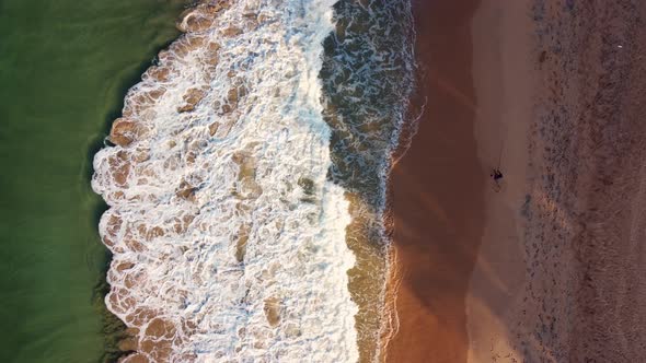 Fisherman, beach and ocean with waves