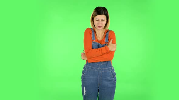 Beautiful Sweet Girl Froze and Trying To Keep Warm Against Green Screen