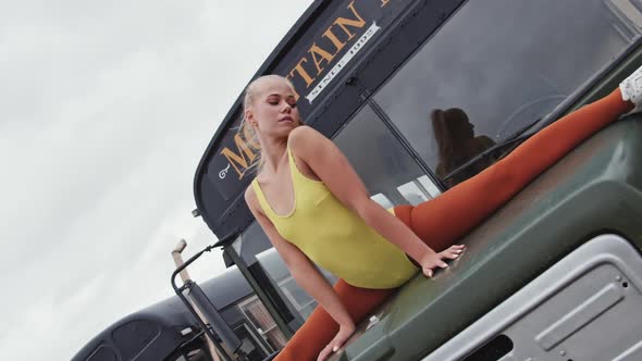 Young Dancer In Yellow Performing Splits On Bus