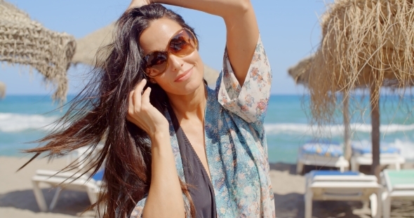 Cheerful Young Lady At The Beach Looking At Camera