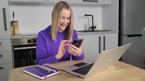 Happy Young Adult Woman Work Study at Kitchen Using Laptop