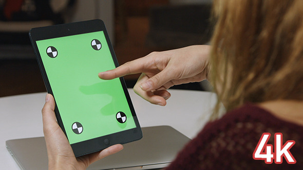 Girl Using Tablet with Green Screen alt