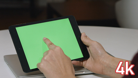 Girl Using Tablet with Green Screen alt