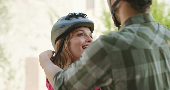 Romantic Active Couple Wearing Helmet To Riding E-bike Bicycles Mtb on a Beutiful Outdoor Woods Path