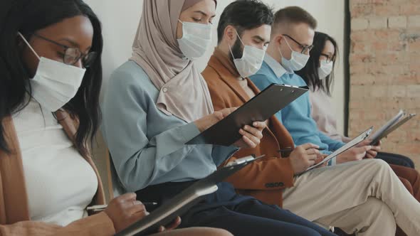 People in Face Masks Waiting for Job Interview