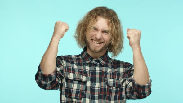 Slow Motion of Handsome Blond Man Celebrating Victory Winning Prize and Cheering Fist Pump and