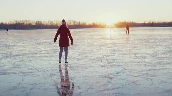 Woman Ice Skating on Frozen Lake