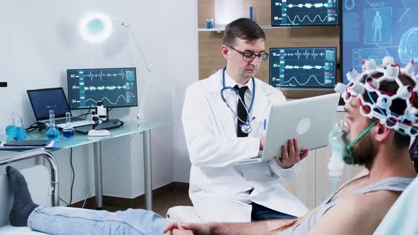 Doctor in Brain Research Using His Laptop in a Modern Centre of Neuroscience