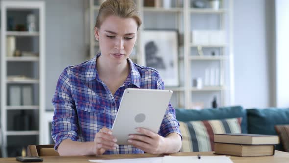 Shocked, Stunned Woman Using Tablet for Browsing