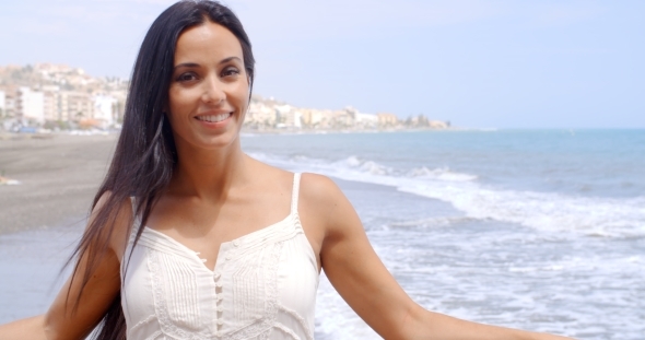 Pretty Lady At The Beach Railing Smiling At Camera