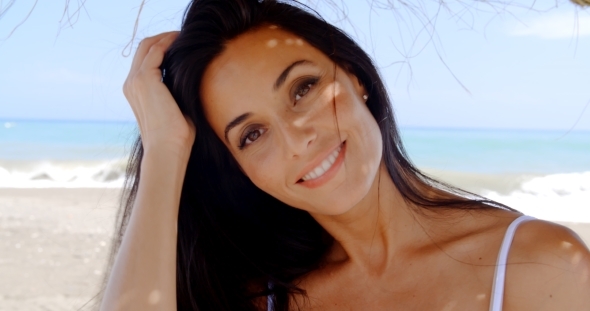 Brunette Woman In Shade On Tropical Beach