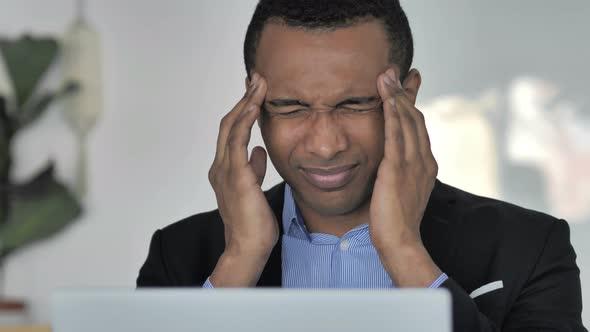 Close Up of Stressed Casual Afro-American Businessman with Headache Working on Laptop