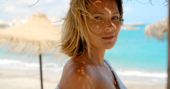 Woman In Grey Sweater In Shade Of Beach Umbrella alt