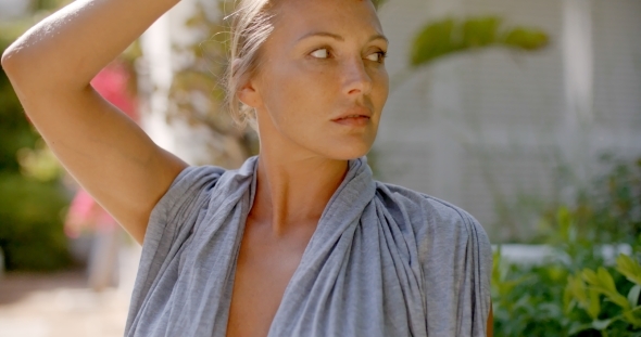Woman In Grey Robe Outdoors Looking At Camera