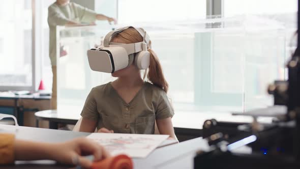 Schoolgirl Wearing VR Glasses during Science Lesson