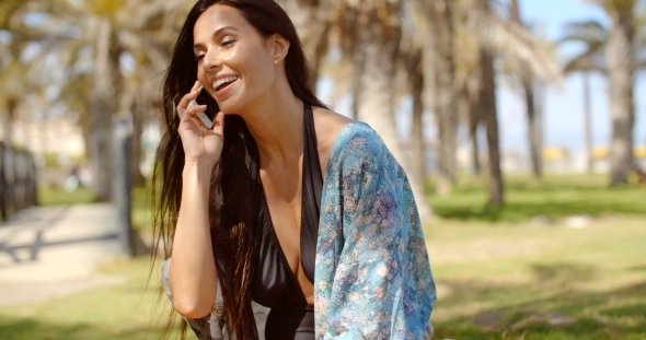 Young Lady In Beach Wear Talking On Phone