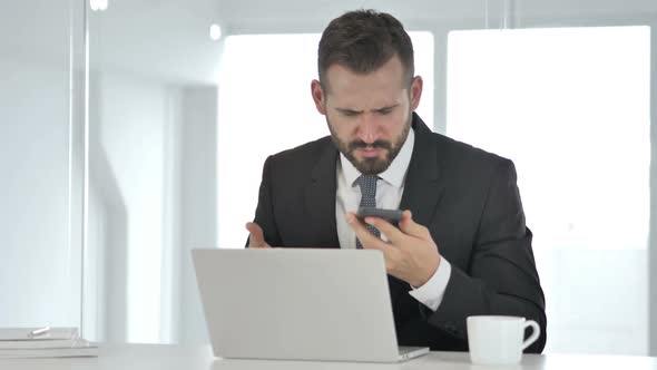Sick Middle Aged Businessman Coughing at Work