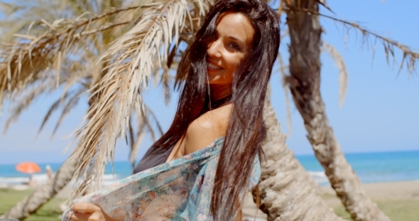 Carefree Woman At The Beach Looking At Camera