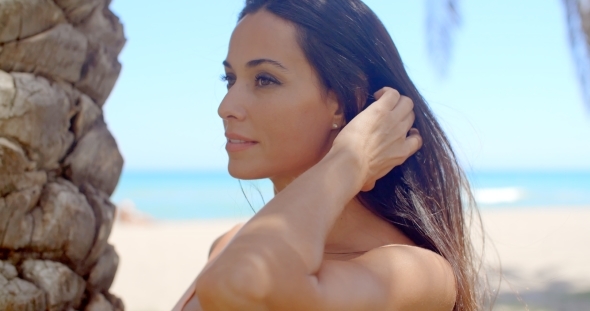 Woman With Long Dark Hair Looking Over Shoulder alt
