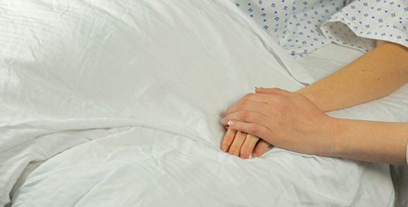 Woman Pats Female Hospital Patient's Hand