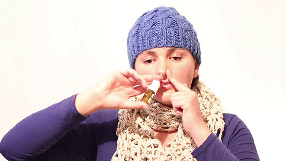 Woman Using Nasal Spray