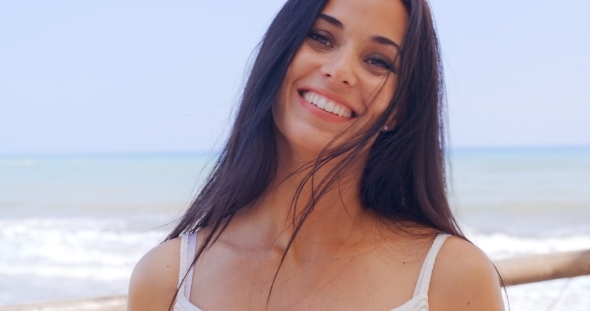 Happy Young Woman At The Beach With a Toothy Smile