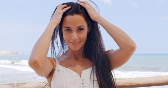 Pretty Young Lady Leaning Against Beach Railing