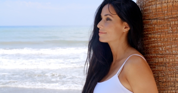 Thoughtful Lady Leaning Against Beach Palm Tree alt