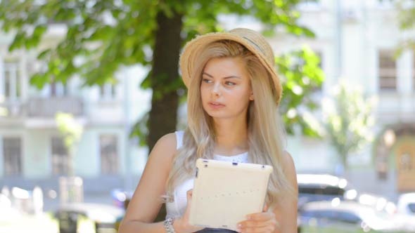 Girl Thinking and Writing Text on Tablet PC