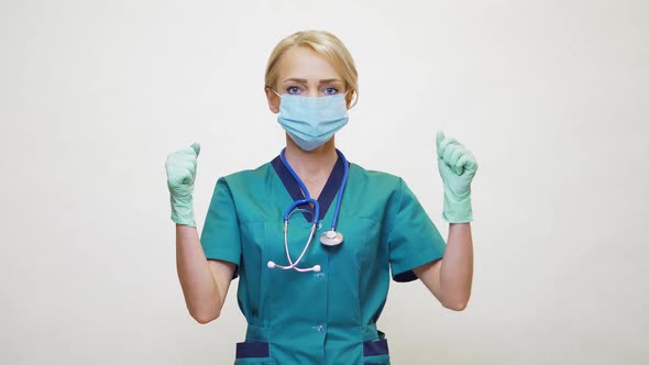 Medical Doctor Nurse Woman Wearing Protective Mask and Rubber or Latex Gloves - Yes Win Gesture
