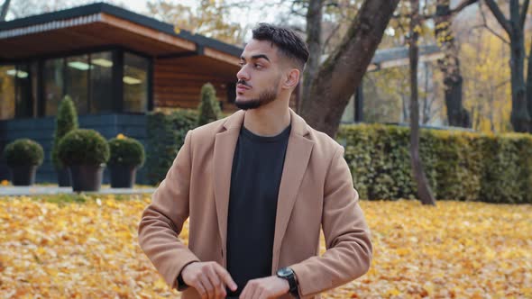 Young Impatient Hispanic Handsome Guy in Autumn Park Man Look Around Waiting for Meeting